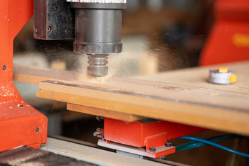 CNC Lathe machine working on wood to lathe and shaping
