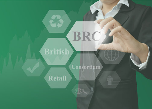 businesswoman showing presentation BRC(British Retail Consortium) on black background.