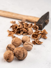 Hammered walnuts on a gray surface.