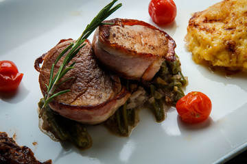 closeup finely decorated restaurant dish of baked meat with sauce