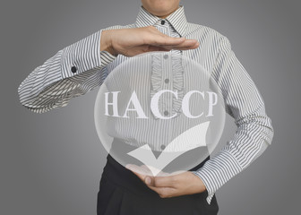 Businesswoman showing HACCP system approved icon or symbol idea for business concept.
