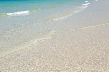 Fototapeta na wymiar Blue sea waves summer background. Sand beach