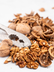 Chopped walnuts with kernels on a gray surface.