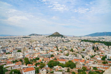 Fototapeta na wymiar Urban Athens spreading out below with landmark Mount Lycabettus in centre of image