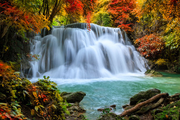 Fototapeta na wymiar Colorful majestic waterfall in national park forest during autumn - Image