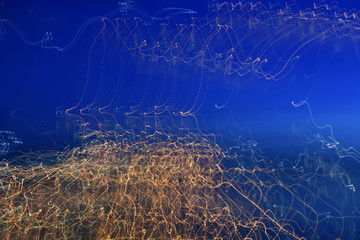 Abstract pattern of light filaments on blue background