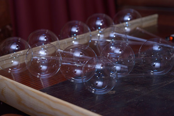 Glassblowing. Blanks of Christmas decorations, balls, placed on a work table