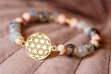 Beautiful mineral gem stone bracelet on pink velvet background