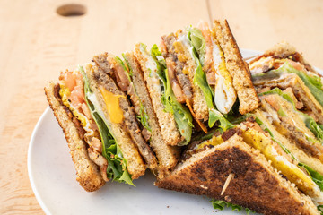 Breakfast cheeseburger with beef, cheese, egg, lettuce, and tomato. A breakfast sandwich for brunch.