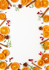 Christmas composition with dried oranges and spices on white background. Natural food ingredient for cooking or Christmas decor for home. Flat lay.