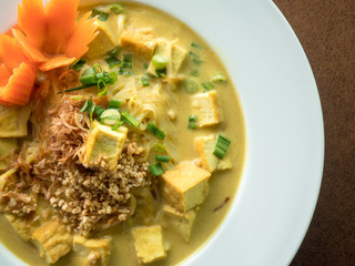 Vegan curry made with tofu, carrots, and potatoes. Authentic vegan thai food. Spicy and aromatic soup. 