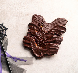 homemade chocolate bat cookies on a light marble backdrop, halloween scene 