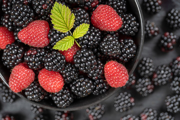 Background from fresh organic blackberries and raspberries, close up. Top view blackberry and raspberry