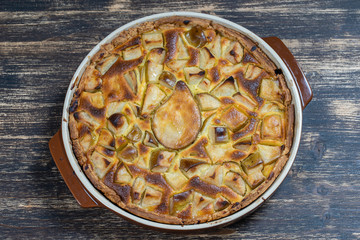 Homemade organic pear pie dessert ready to eat. Pear tart on the old wooden background, close up