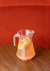 Fruit punch in a glass pitcher. A refreshing summer beverage served in a restaurant.