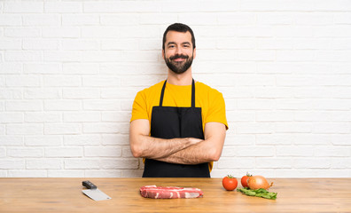 Chef holding in a cuisine keeping the arms crossed in frontal position