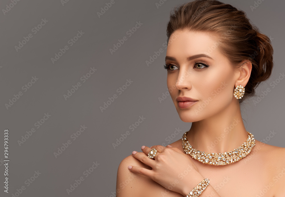 Wall mural beautiful girl with set jewelry . woman in a necklace with a ring, earrings and a bracelet. beauty a