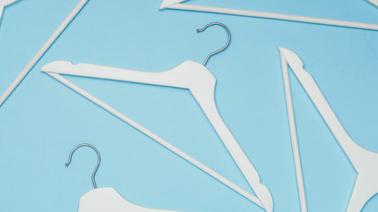 Hangers / Top view of white clothes hangers / Flat lay / Minimalism style / Fashion, store sale,...