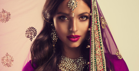 Portrait of beautiful indian girl . Young hindu woman model  in sari and  kundan jewelry . Traditional India costume lehenga choli . Eastern or Arabic culture.