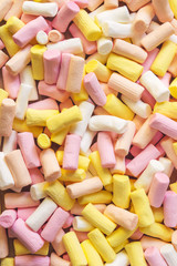 Background of colorful mini marshmallows, vertical image