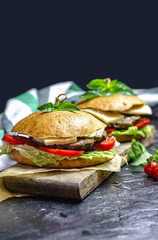 Healthy homemade burger with beef, tomatoes, cheese and basil. Copy space