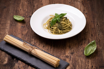 Spaghetti Pesto alla Genovese on rustic wooden table