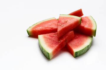 Slices of watermelon on a white background. Mountain of berries