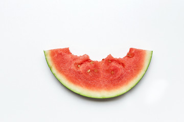 Slice of watermelon on a white background. Bite marks on a slice of watermelon.