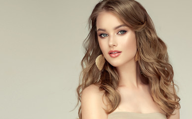 Beautiful model girl with elegant hairstyle and fashionable leaflet earrings . Woman with fashion  hair   and  accessories and jewelry .. - 296797395
