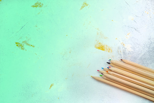 a set of colored pencils on a gray concrete background. Concept back to school 3x8 banner