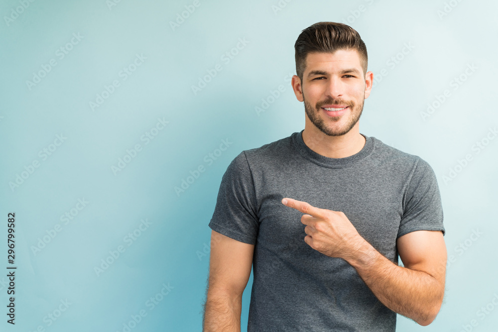 Wall mural attractive male is gesturing in studio