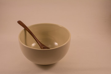 Spoon in bowl on a light background