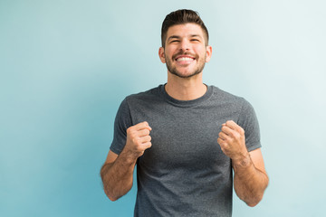 Handsome Latin Man Smiling In Excitement Against Turquoise Background