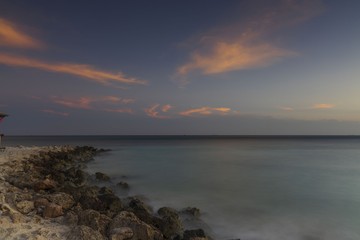 Fototapeta premium Gorgeous colorful view of sunset on Aruba. Beautiful nature landscape. Rocky coast of Atlanta, Caribbean.