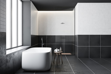 Side view of tiled bathroom, tub and shower