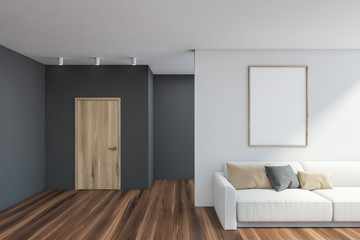 Fototapeta premium Gray and white living room with sofa and poster
