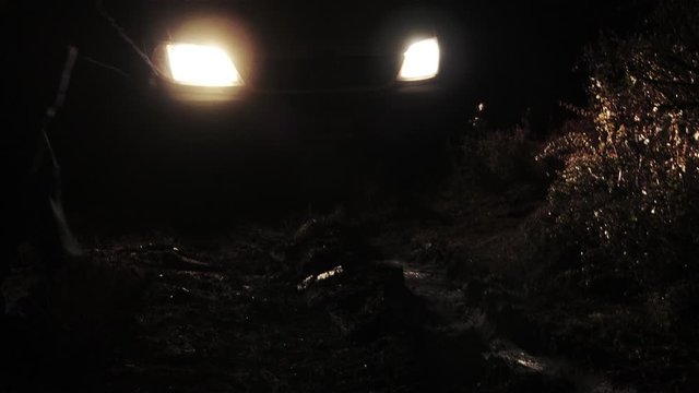Car Stuck in a Muddy Field on a Cold Dark Night.