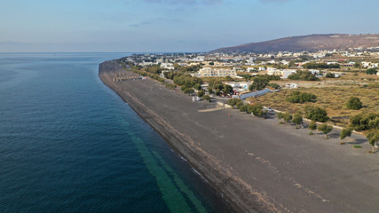 Aerial drone photo of famous volcanic beach and bay of Perissa village, Santorini island, Cyclades, Greece
