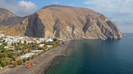 Aerial drone photo of famous volcanic beach and bay of Perissa village, Santorini island, Cyclades, Greece