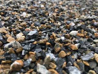 The backdrop concept of multicolored pebbles laid together on the floor.