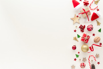 Christmas composition. Santa hat star gift bauble pine cone elements set top view background with copy space for your text. Flat lay.