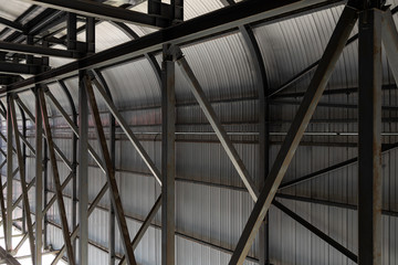 Corrugated metal wall and metal beams welded to it