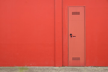 Fototapeta premium Cement concrete wall texture with modern red door.