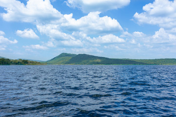 Lake swamp and green mountains, together with the blue sky and beautiful clouds