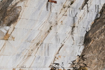 White Carrara marble quarry in the Apuan Alps in Tuscany. Mountain walls cut with diamond wire.