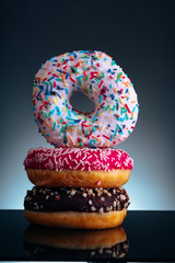 Delicious sweet donuts on black background