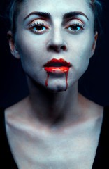 Zombie woman with bloody lips and blue skin portrait. Fashion glamour halloween art design concept