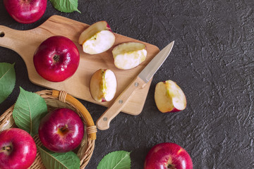 apples and apple slices on a cutting Board top view. background with apples. red apples lay flat.