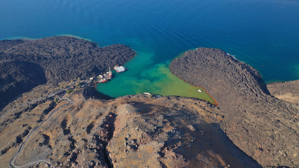 Aerial drone top down photo of iconic main Crater of Santorini volcanic island called Kameni visited by tourist boats, Cyclades, Greece