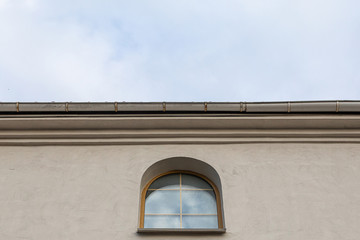 Small wooden church window under roof
